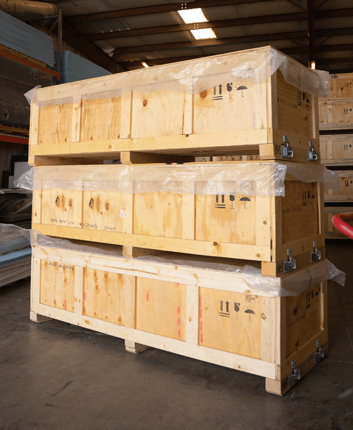 Wooden crates with MIL-SPEC numbers stenciled on their sides, showcasing precision-built military-grade packaging