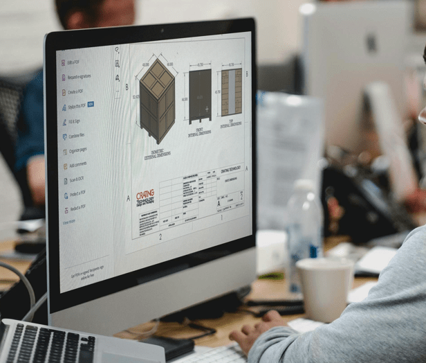 A detailed AutoCAD drawing displayed on a laptop screen, showcasing precise technical schematics, with a focus on engineering and design