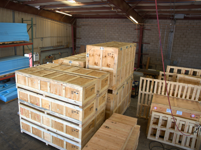 Wooden crates with MIL-SPEC numbers stenciled on their sides, showcasing precision-built military-grade packaging.