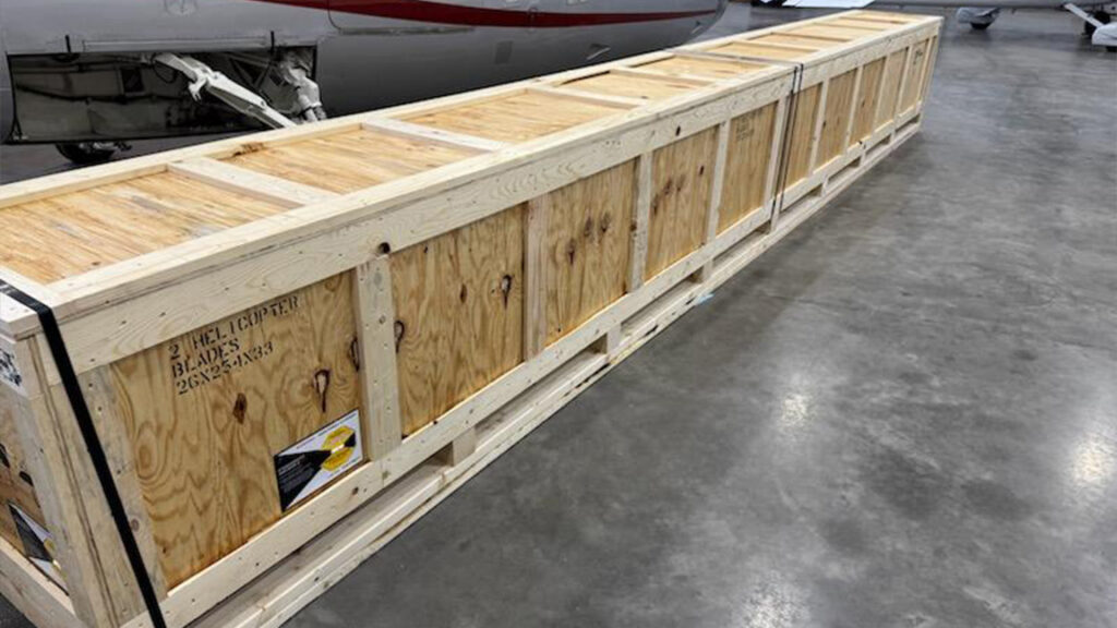 Fully assembled custom wood crate designed for helicopter blades, ready for secure shipment with reinforced construction.